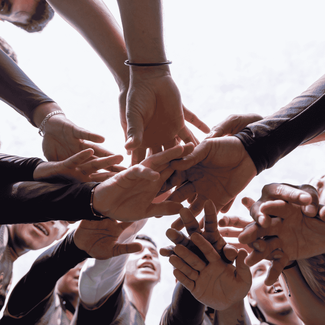 A group of people putting their hands in