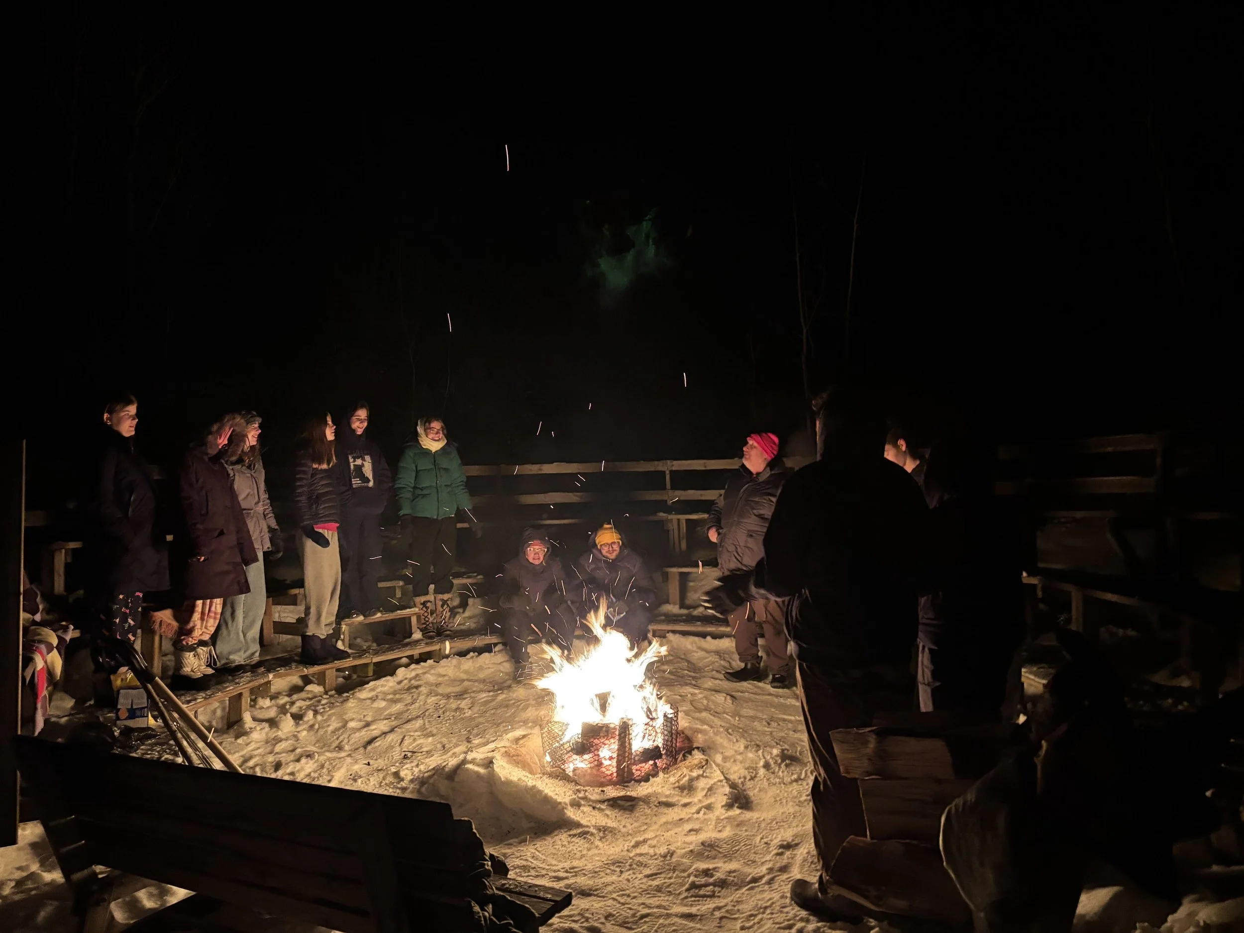 A group of people gathered around a fire