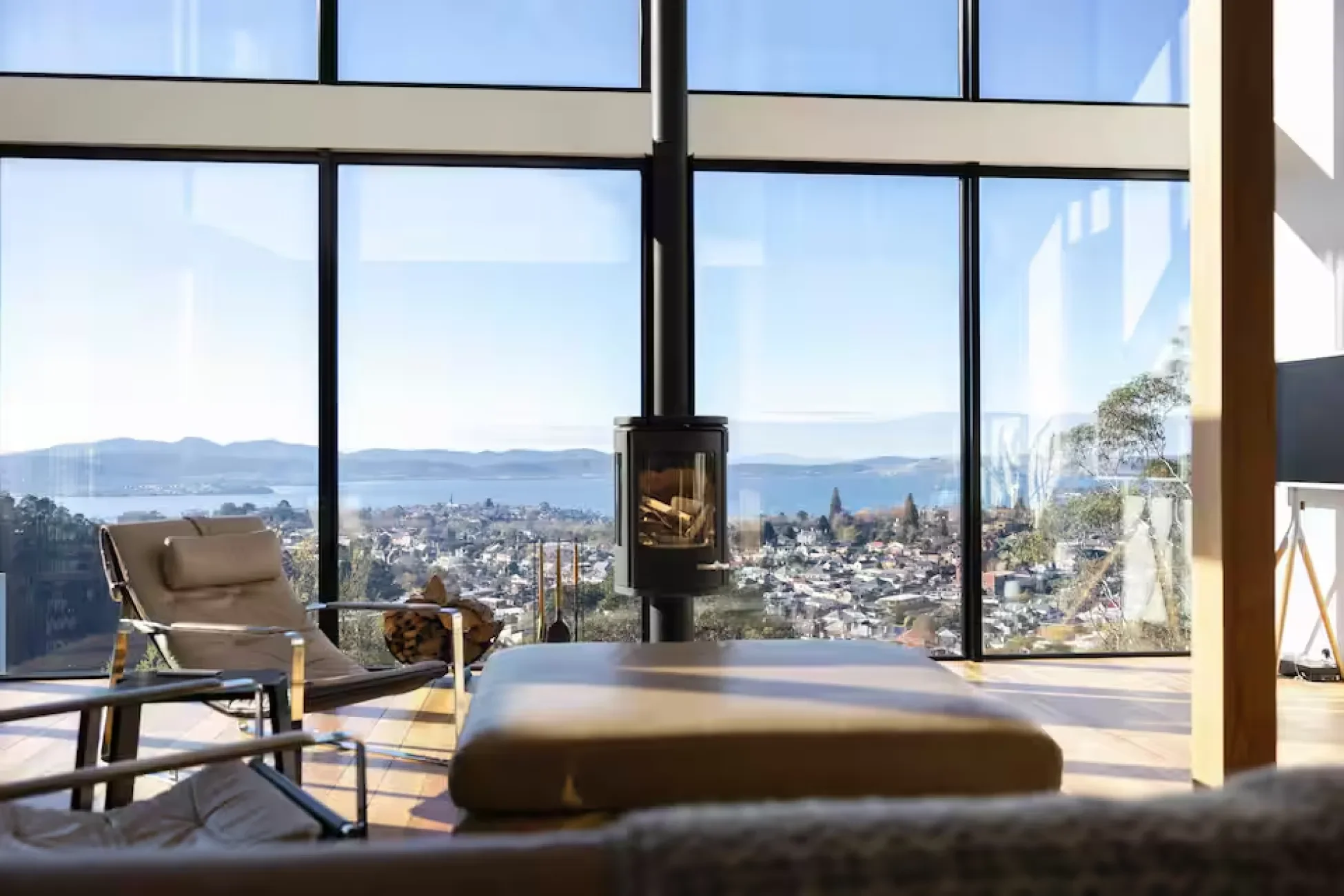 Floor-to-ceiling windows overlooking Hobart from the living room at Glass Holme.
