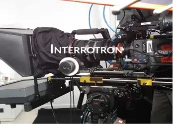 Close-up of a camera mounted on an optical table with scientific equipment, labeled 'INTERROTRON'.