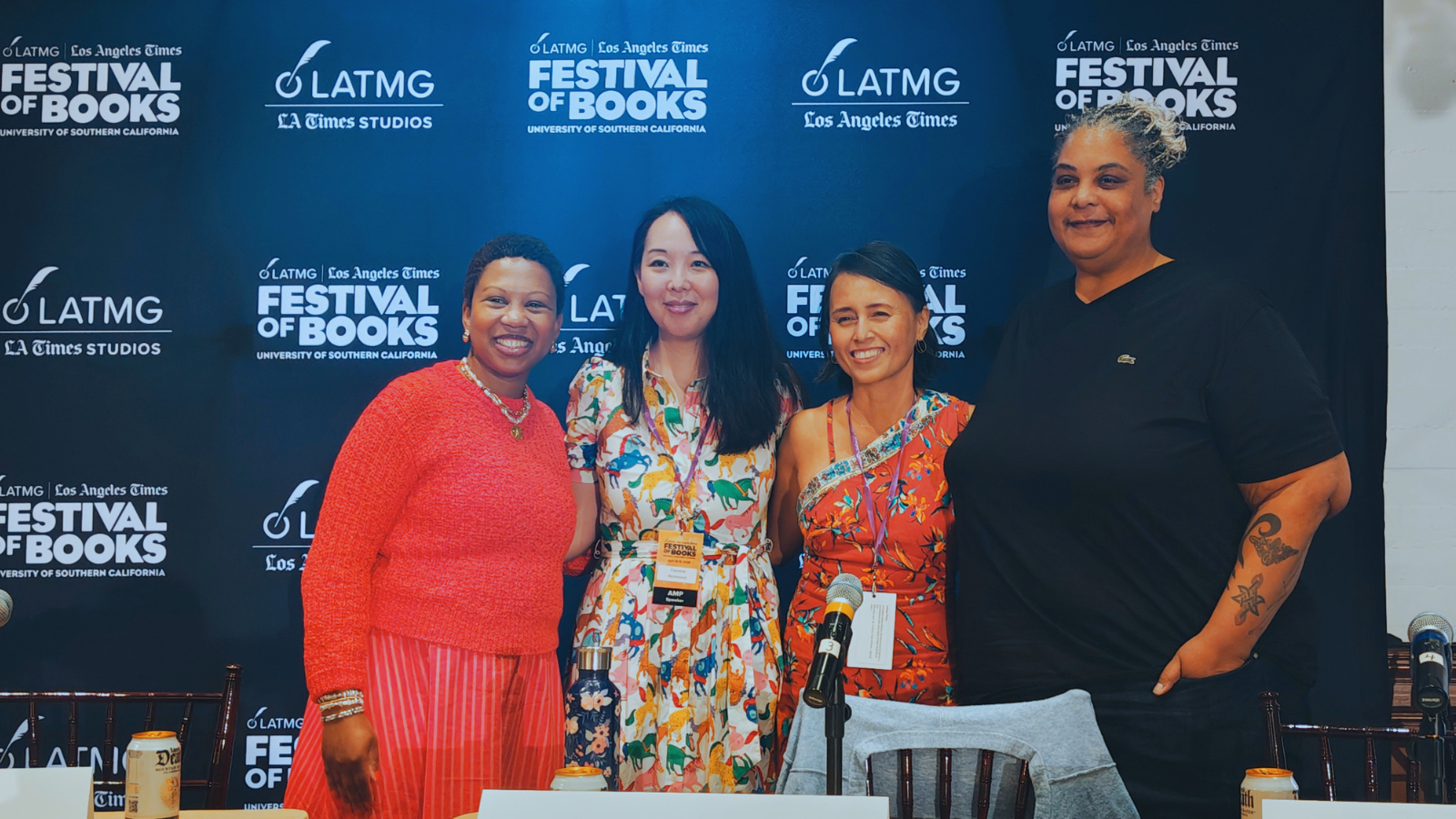 WNDB staff, board members, and moderator stand together following a panel at the Los Angeles Times Festival of Books event, smiling in front of a dark blue backdrop with the event logo.