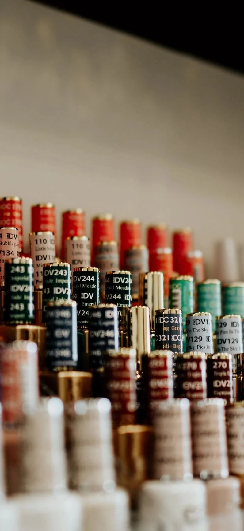 Close-up of colorful shotgun shells arranged in rows on a surface.