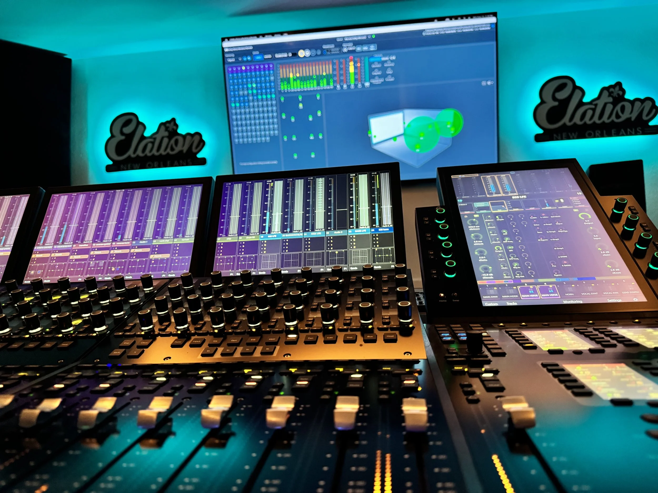 Elation Dolby Atmos control room with mixing console and blue Elation neon signage