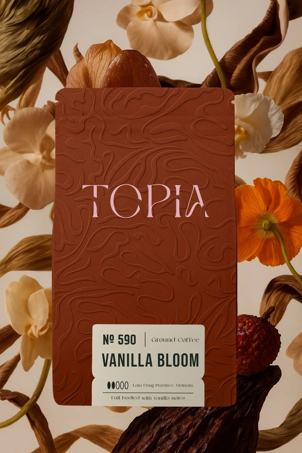 Close-up of a coffee packaging labeled 'Topology, No 590, Ground Coffee, Vanilla Bloom' with floral and natural elements in the background.