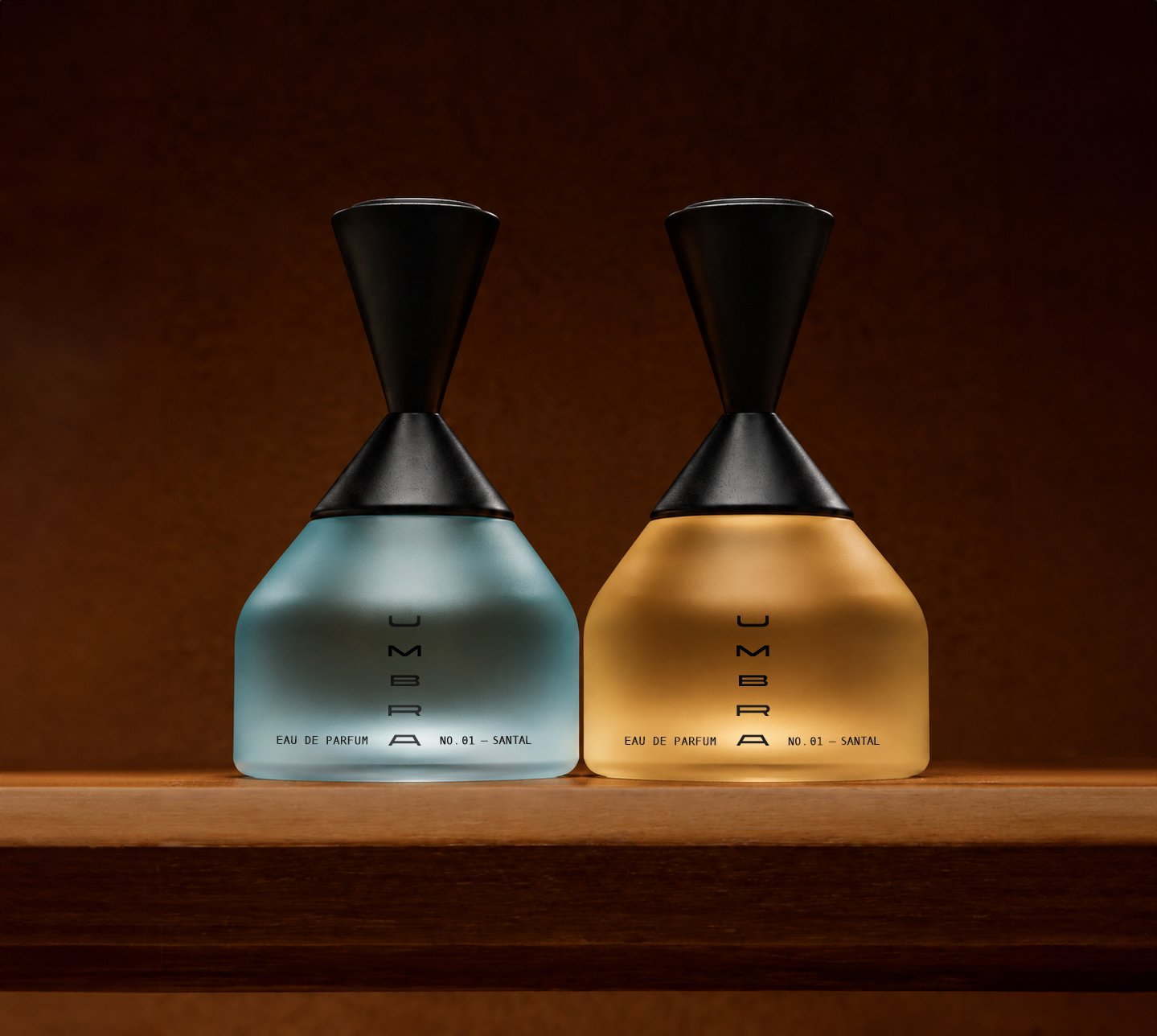 Blue and amber UMBRA perfume bottles illuminated by warm cinematic light