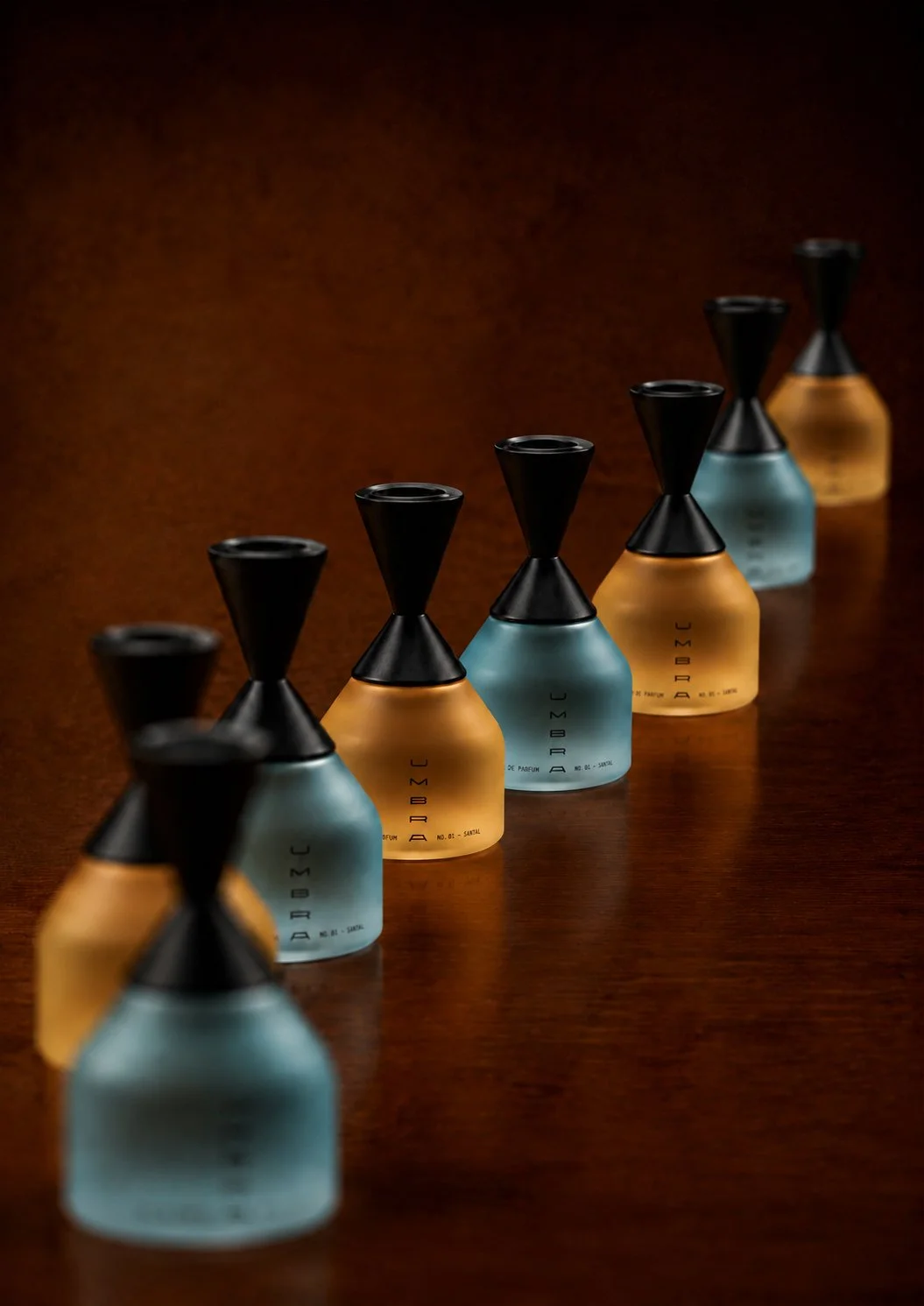 UMBRA fragrance bottle collection in blue and amber frosted glass