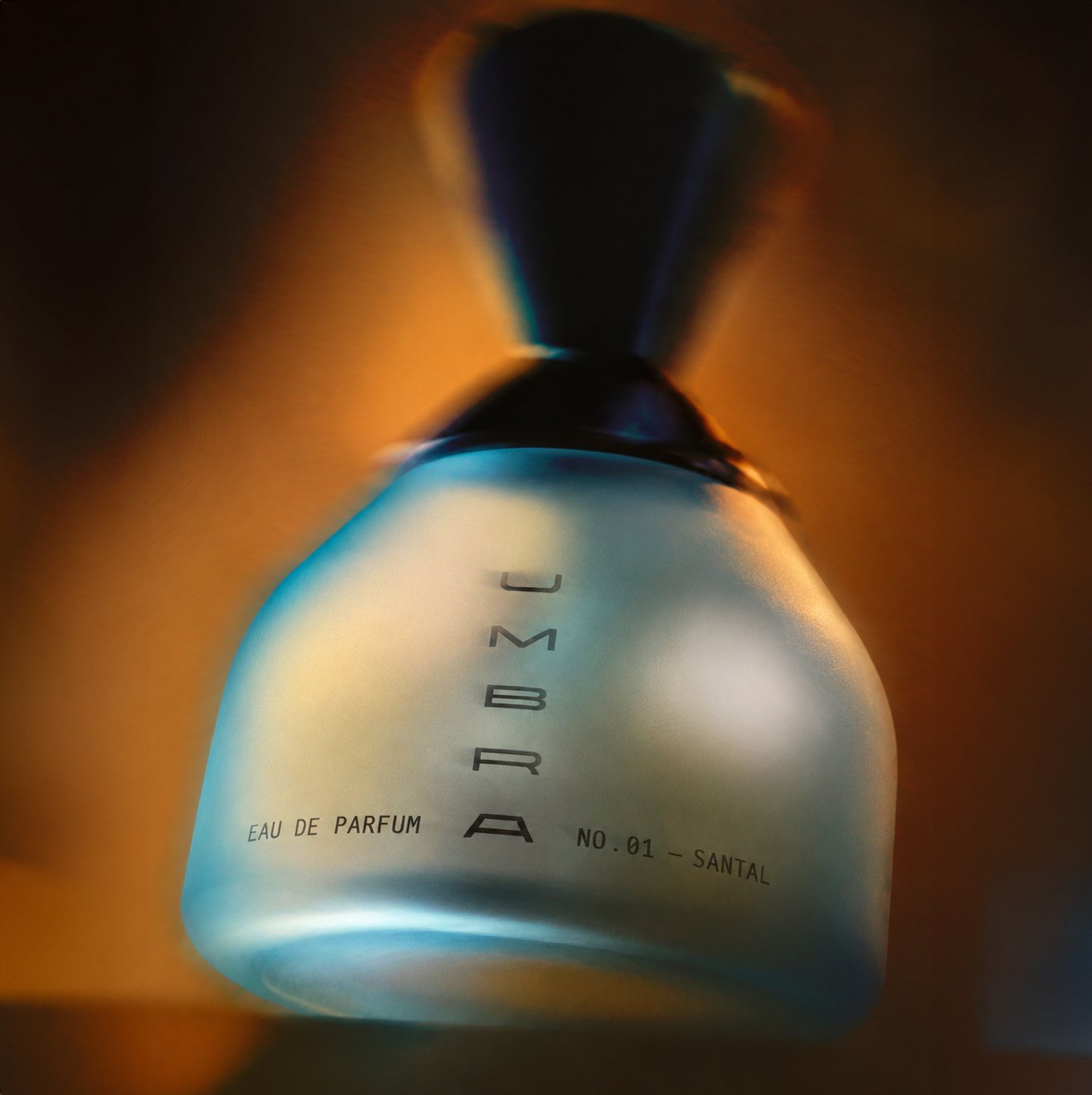 Amber UMBRA fragrance bottle blurred