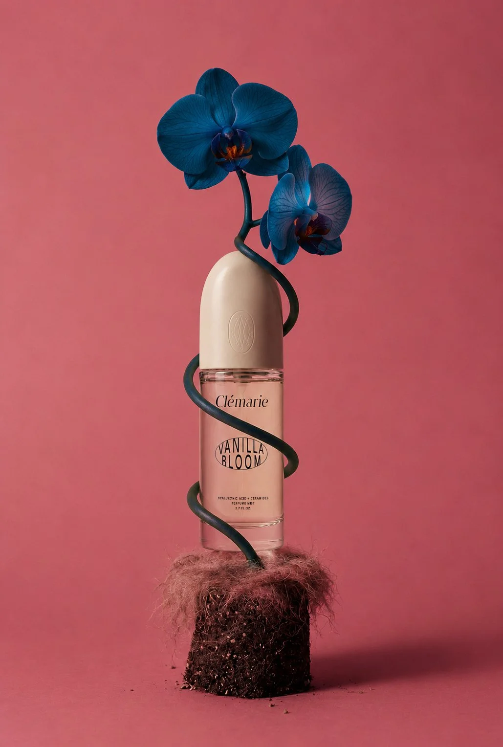 Pink Clémarie beauty bottle with sculptural blue flowers
