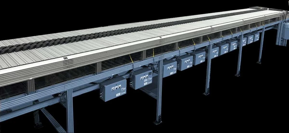 Aegis dual density sorter shown in empty distribution facility environment with blue base and silver top along with black sliding shoe sorters on top.