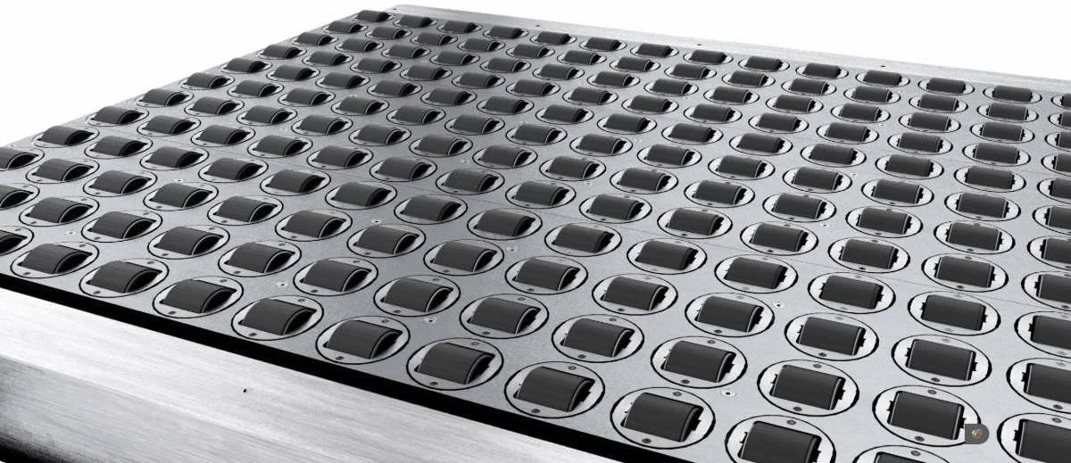 Aegis SmartSort steerable wheel sorter with multiple steerable wheels in a grid that composes the top of the SmartSort table, used for distribution and parcel automation.