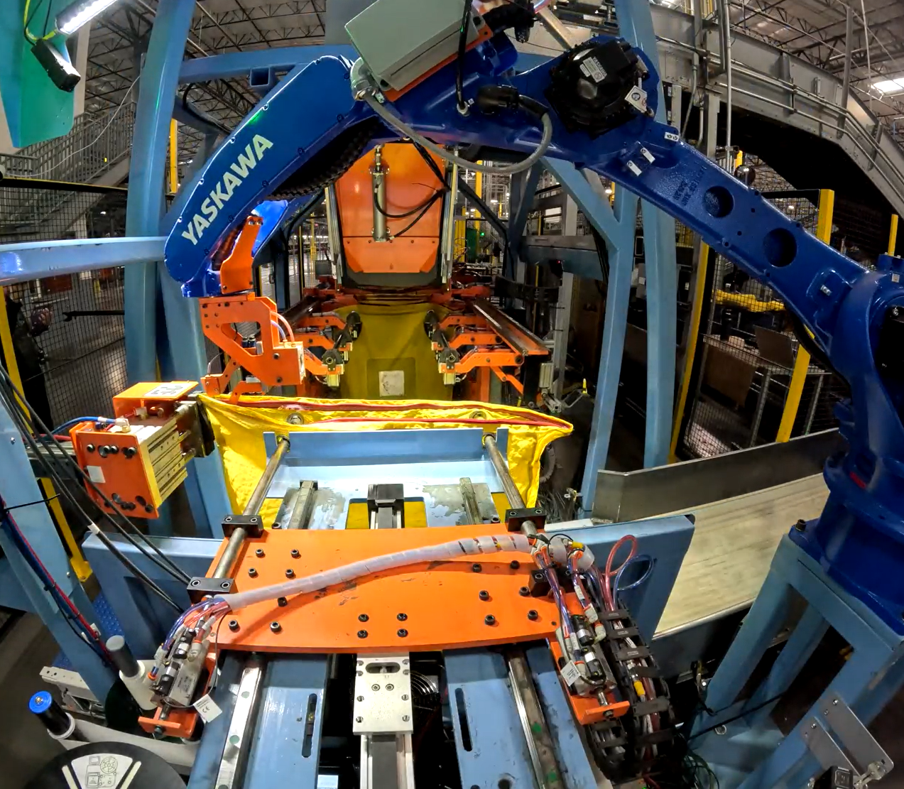 Automated robotic arm zipping bag in a distribution facility for pharmaceuticals.