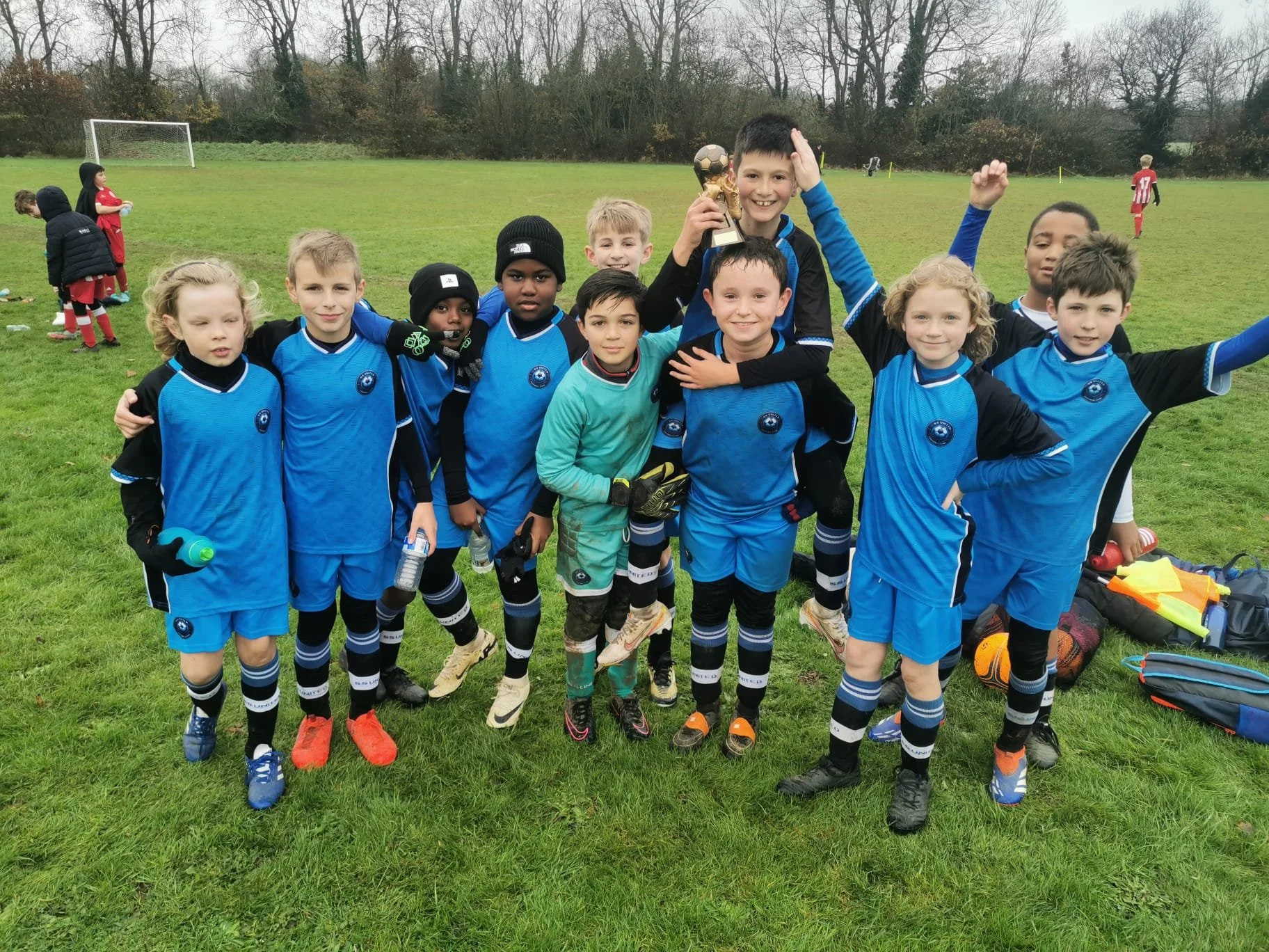 Junior football squad at SS United FC smiling after match