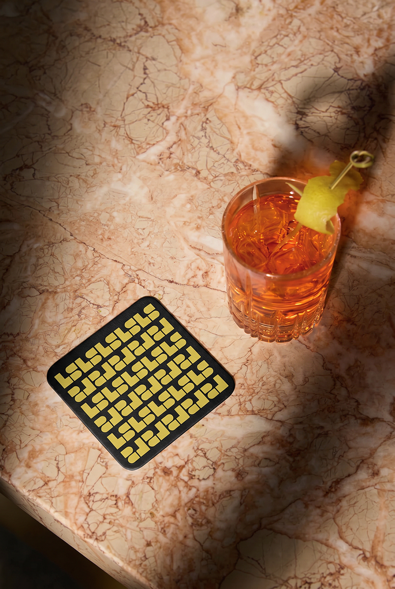 LS Designed Coaster on a marble table with a cocktail