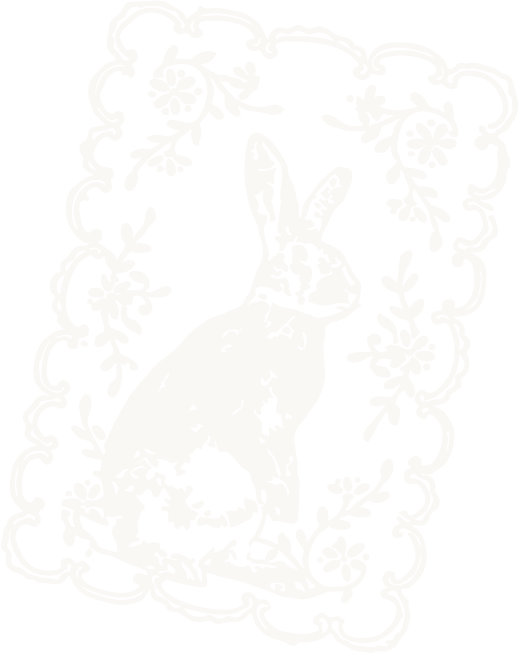 Silhouette of a rabbit with a carrot, surrounded by floral patterns in a decorative frame.