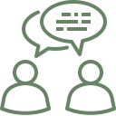 Two simplified human icons with a speech bubble indicating conversation.