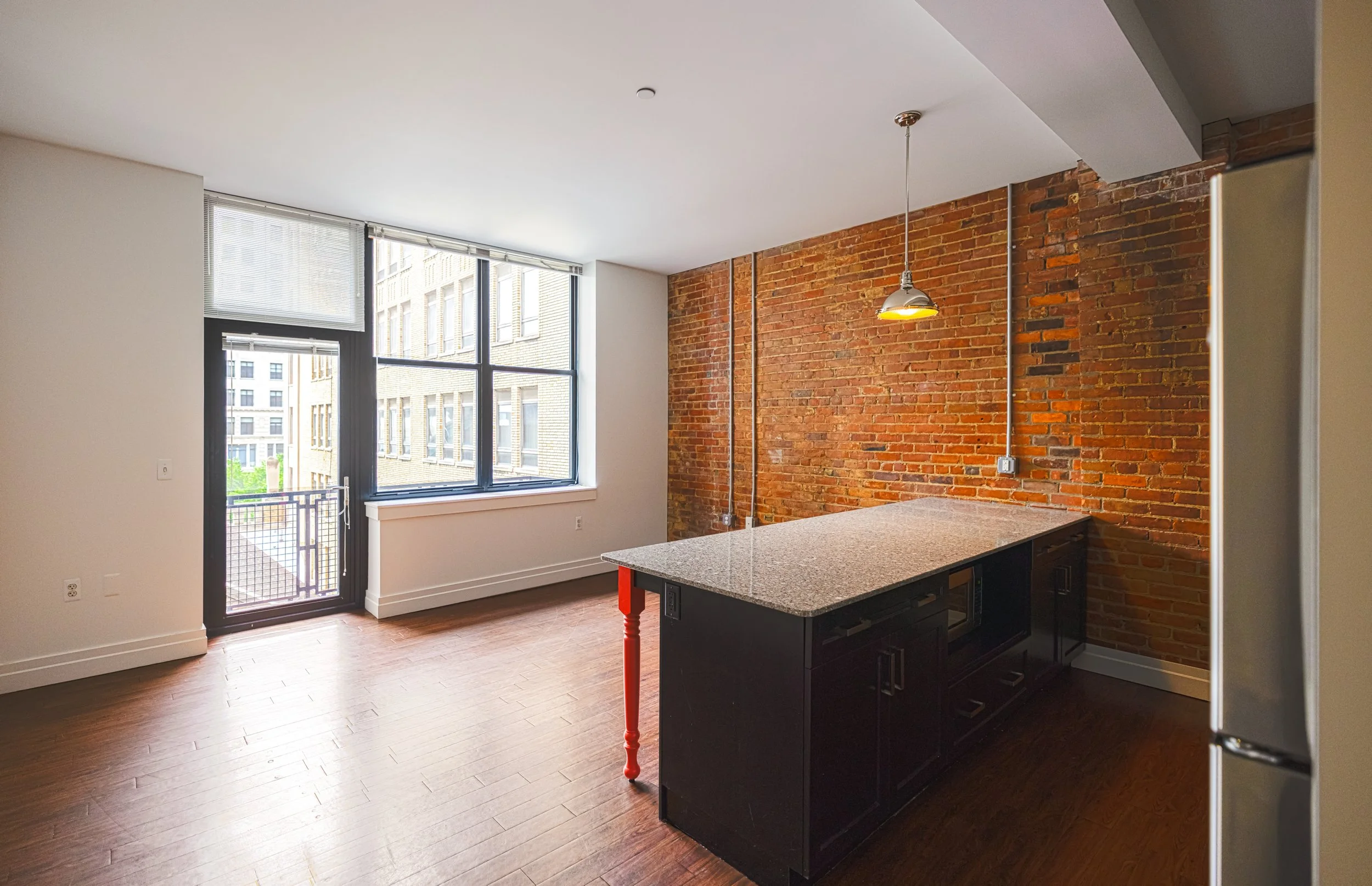 The Malcomson apartment unit showcasing open concept kitchen and patio.