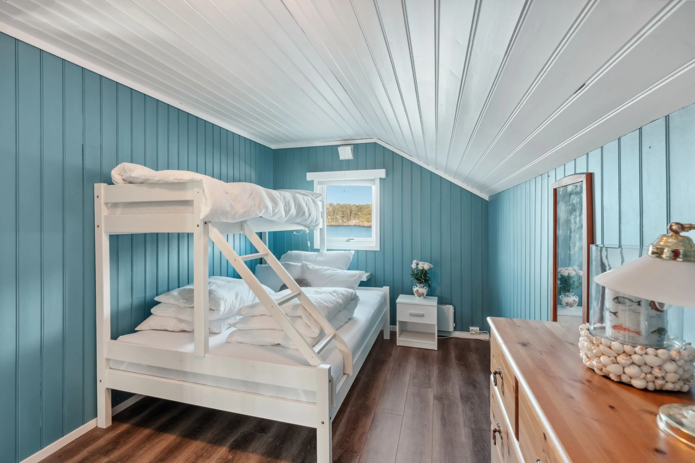 Bright bedroom in cabin at Furiholmen with peaceful surroundings