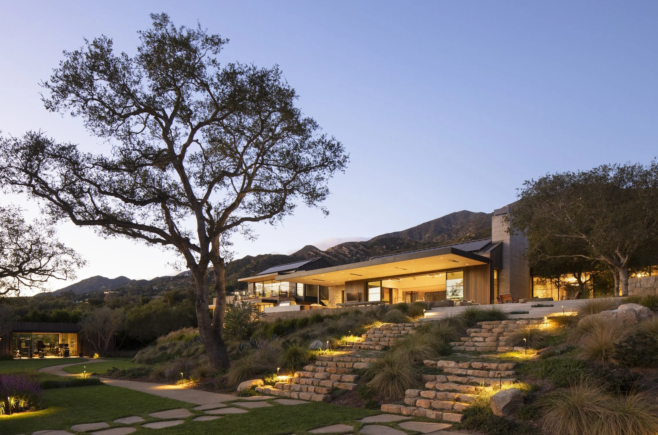 Twilight architectural photography of a luxury home in Santa Barbara with landscape lighting.