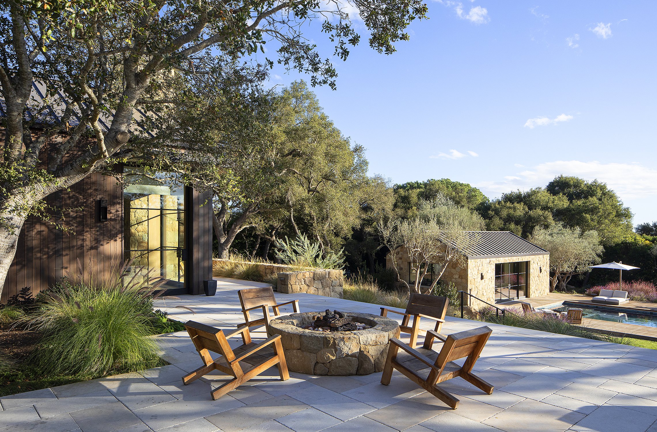 Fire pit and deck on a stone covered patio 