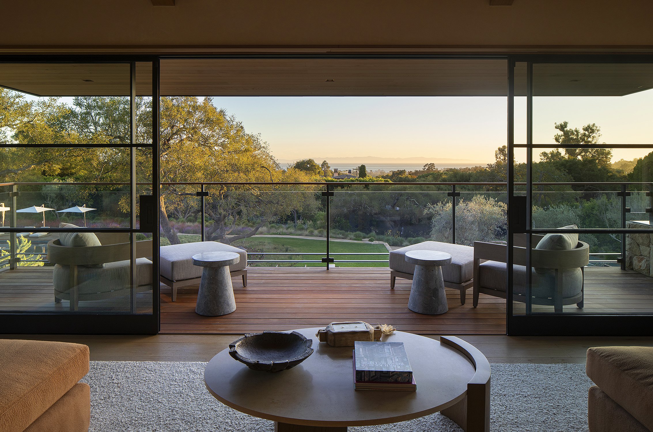 Interior of an office overlooking the pool as the sun sets 