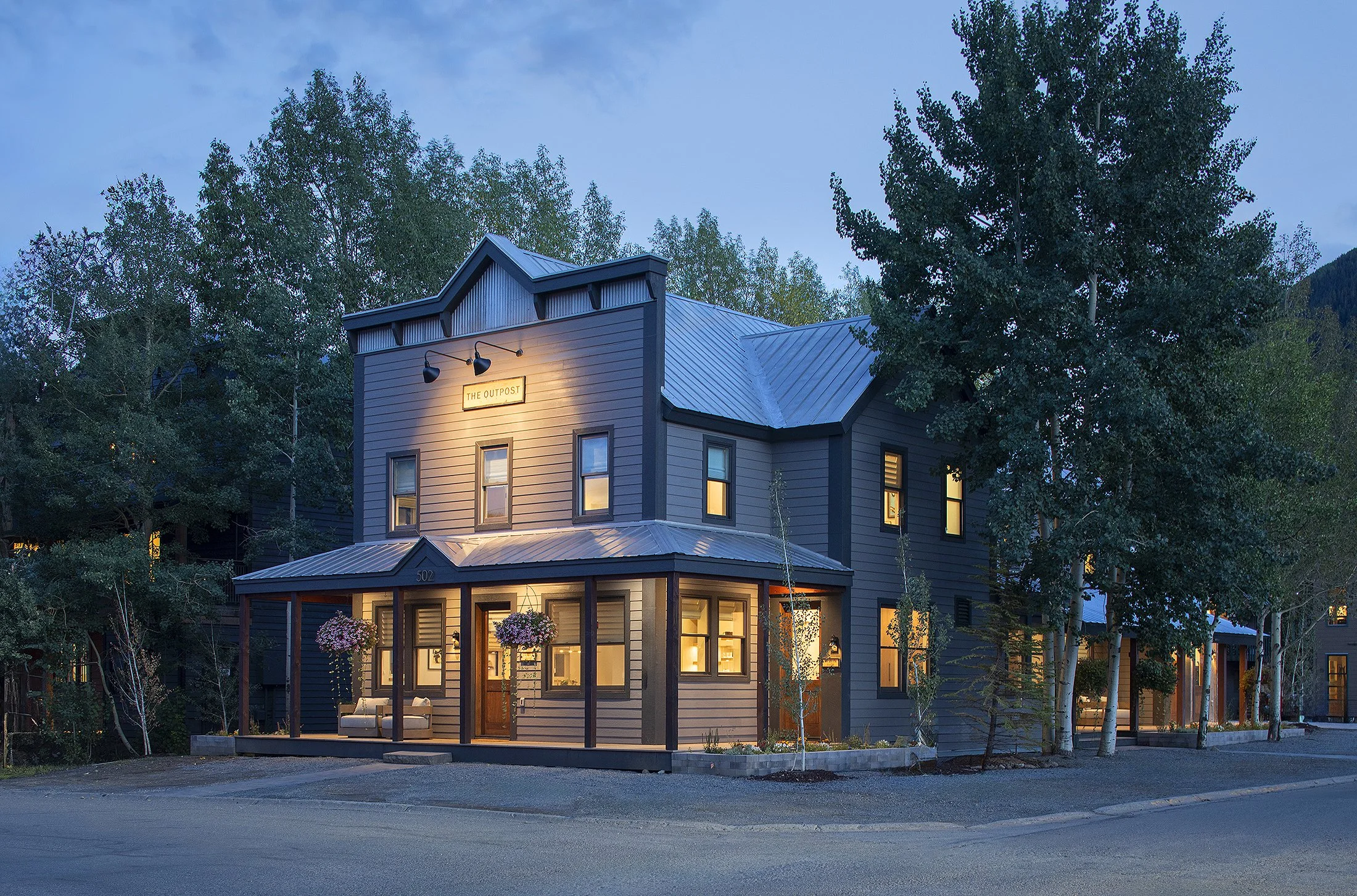 Dusk exterior of a false front building glowing in the evening
