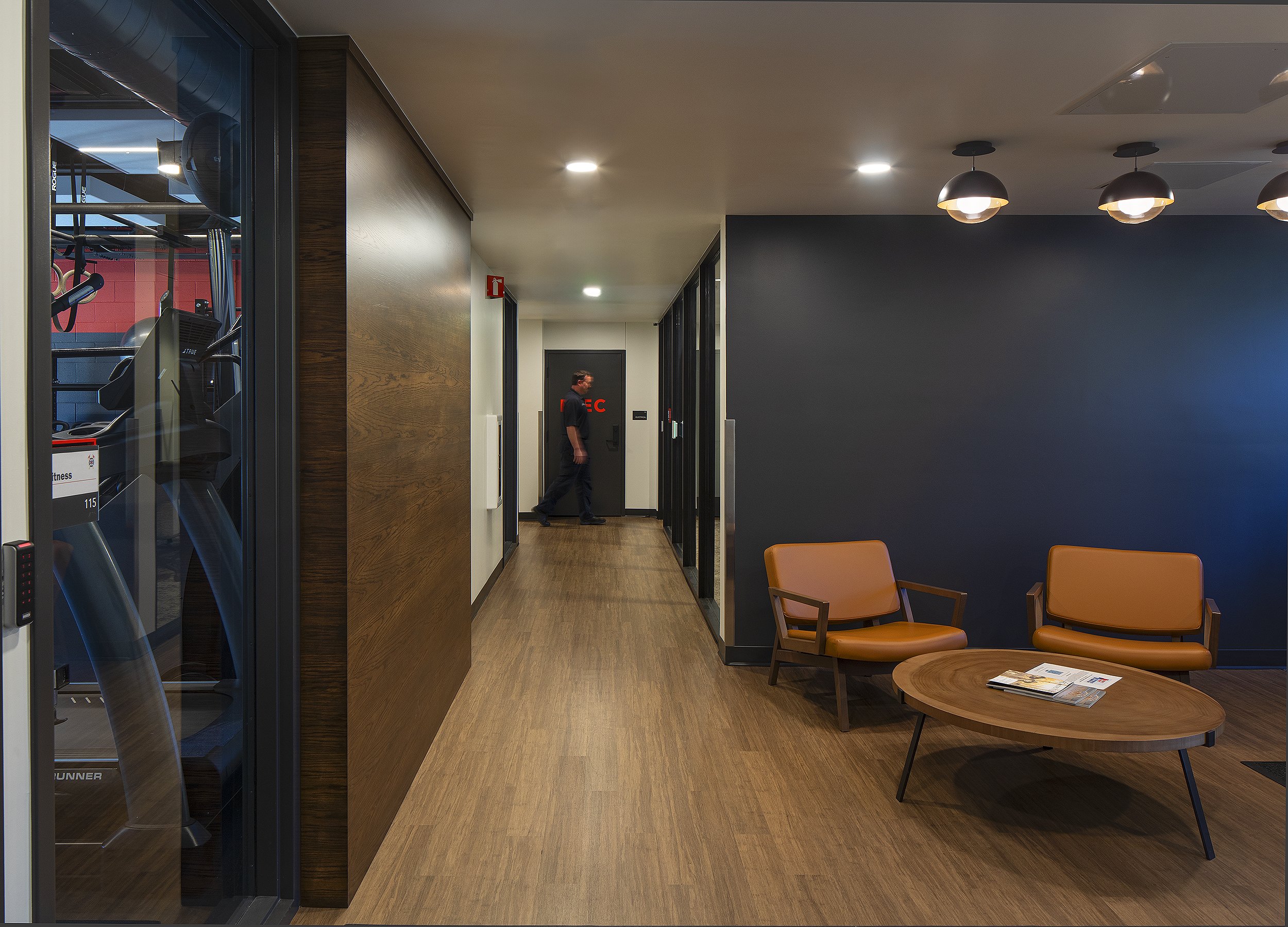 Interior of fire station waiting room with fire fighter walking by