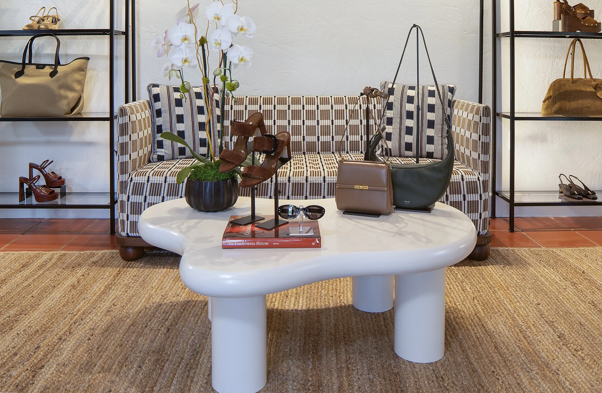 Coffee table with purse and sunglasses displayed in Sacks 5th Avenue showroom Santa Barbara, California 