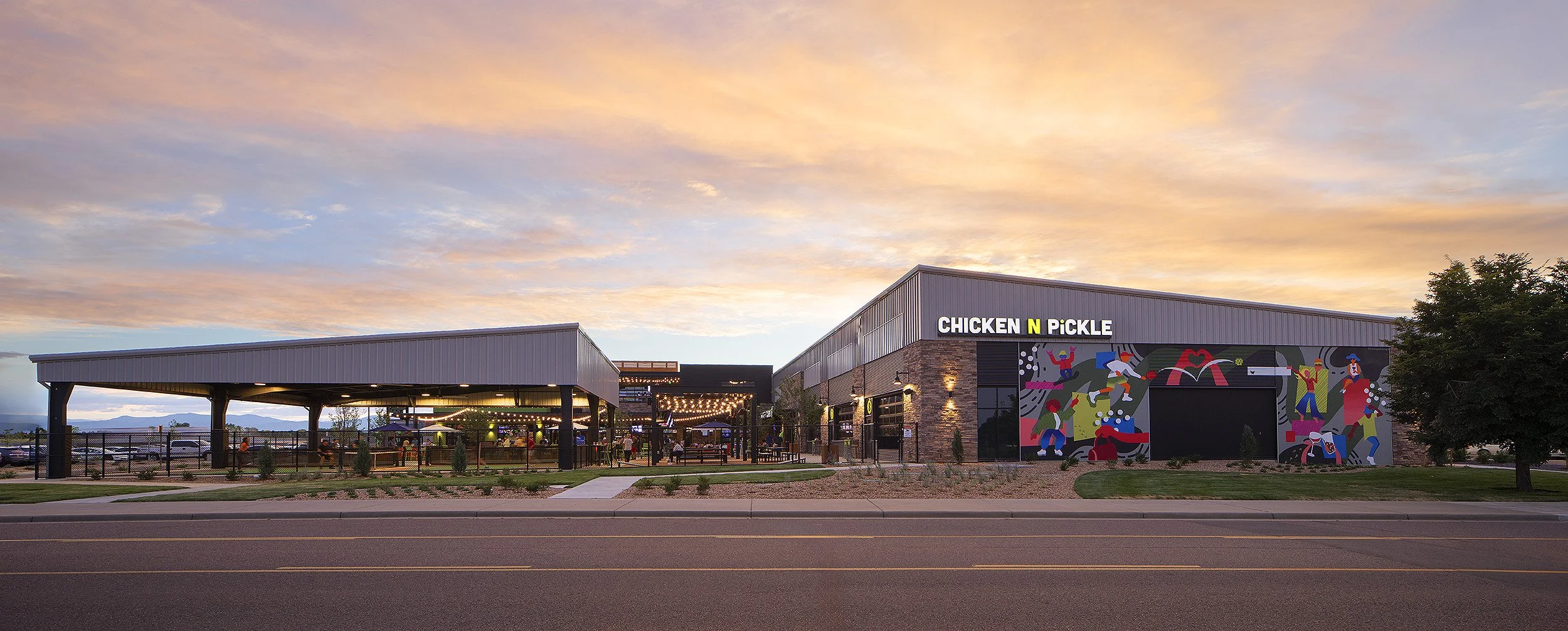 Chicken N Pickle building at dusk in Thornton Colorado