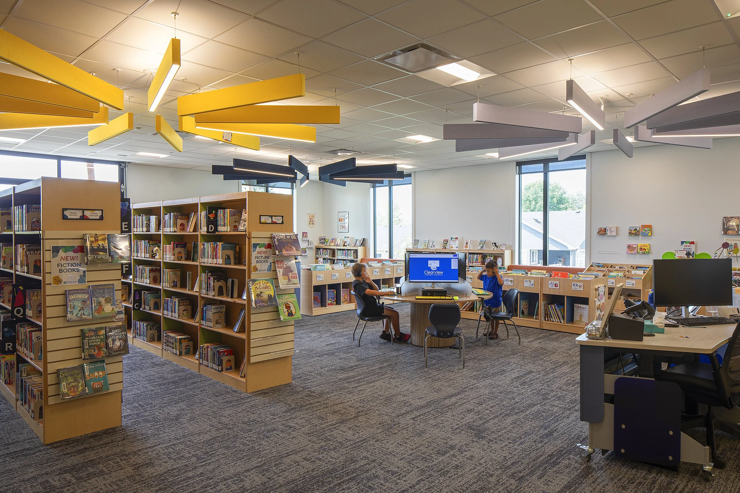 Severance library with yellow and white light fixtures from the ceiling