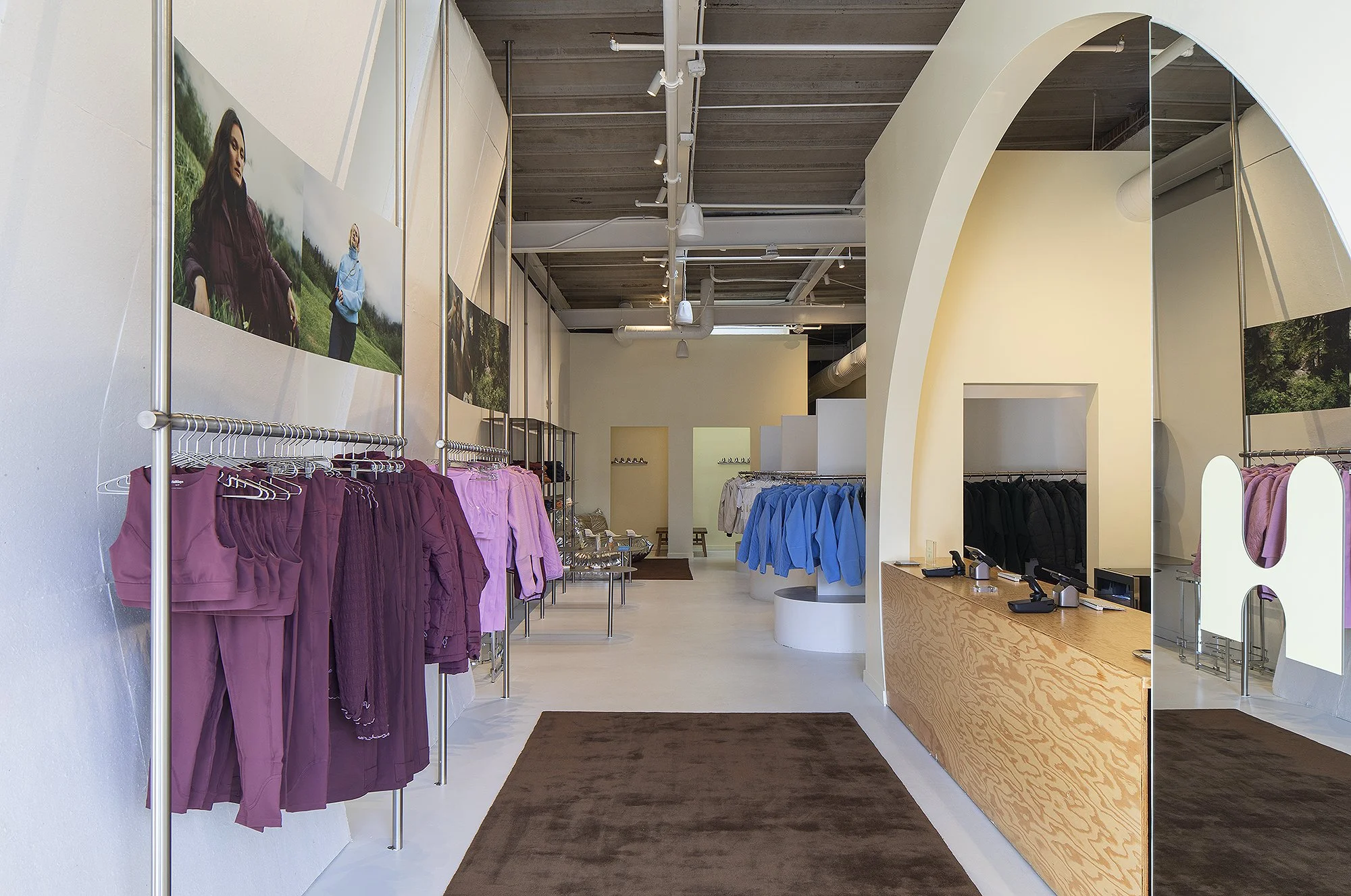 Interior of Half Days retail shop in Denver, magenta clothes on rack to the left