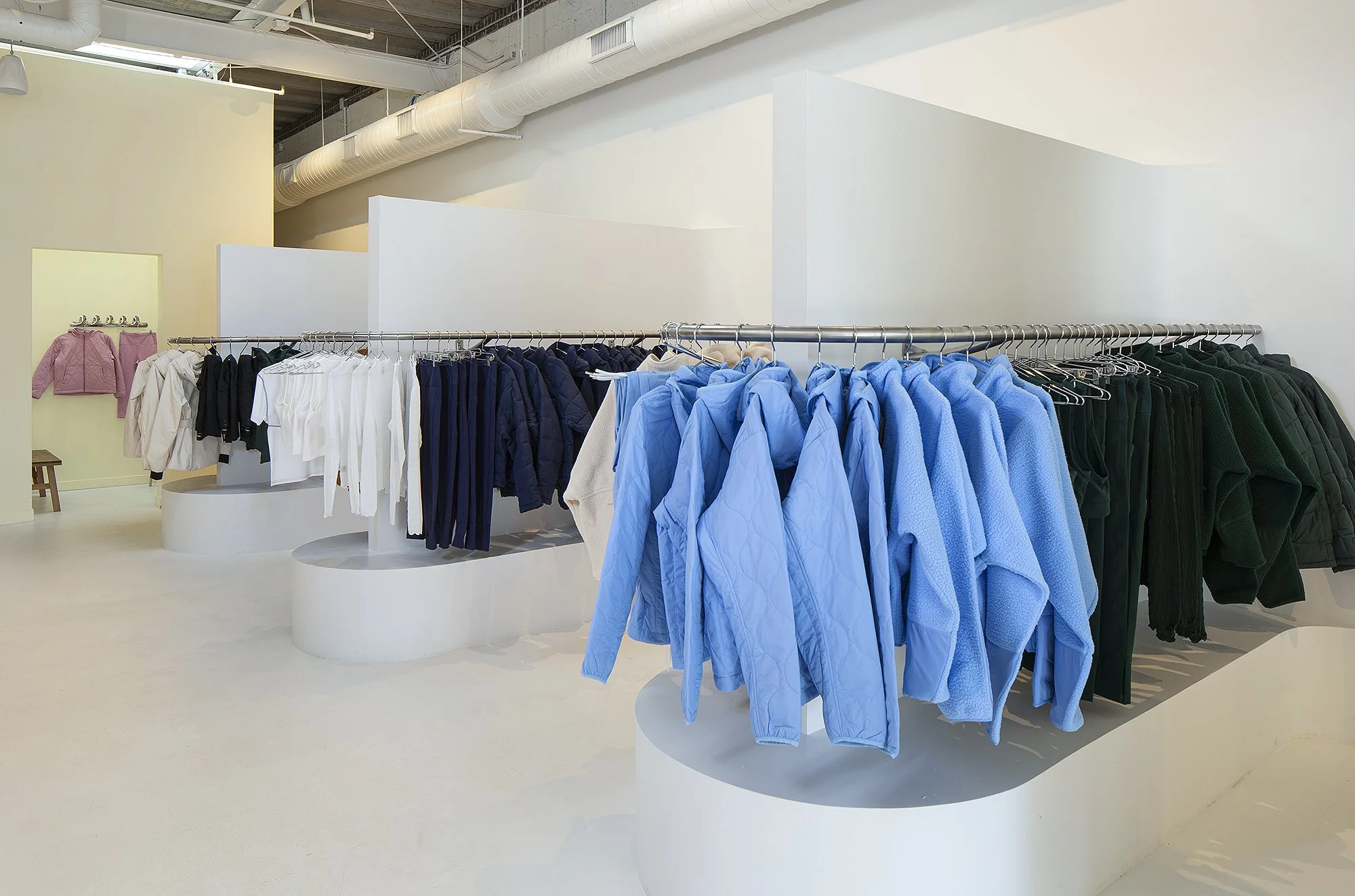 Blue, white and black jackets on display rack in half Days retail store in Denver 
