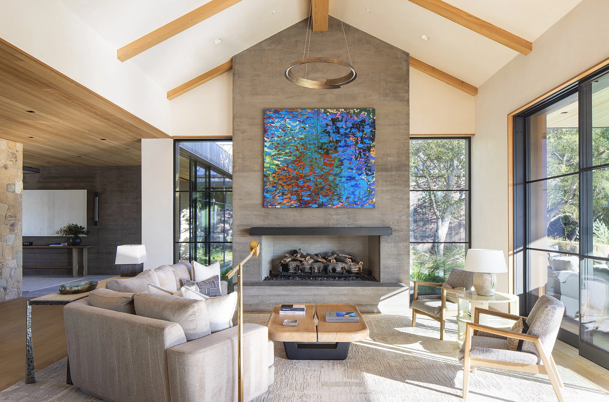Interior living room with blue colorful painting over the fireplace Santa Barbara, California 