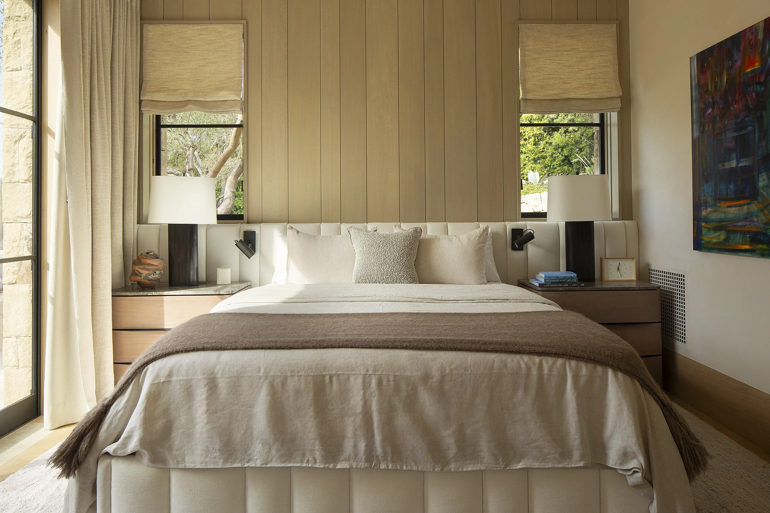 Immaculate bed with white pillow and light brown lap siding 