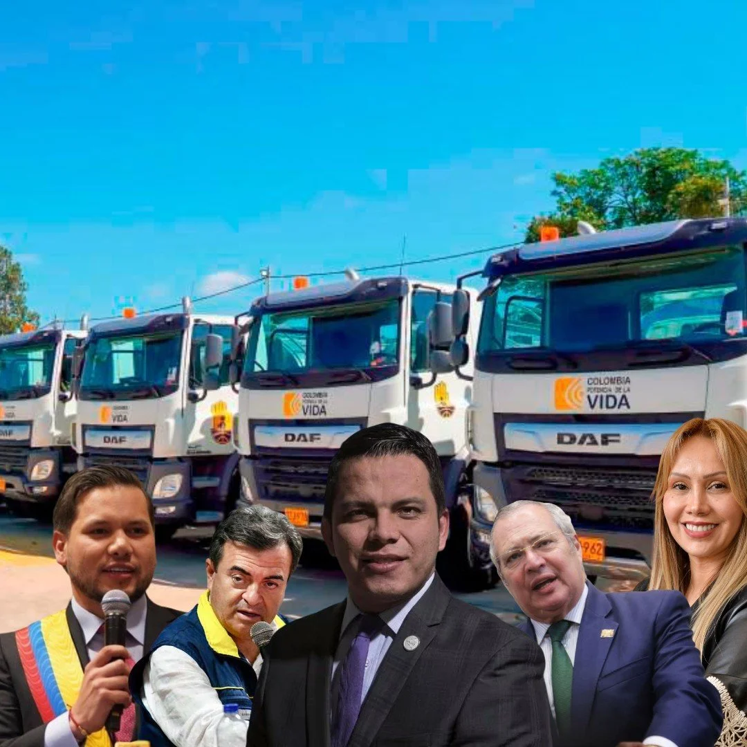 Camiones de basura con el logo de Colombia Puerta de la Vida y personas en primer plano, algunos con micrófonos, en un entorno urbano con árboles y cielo despejado.