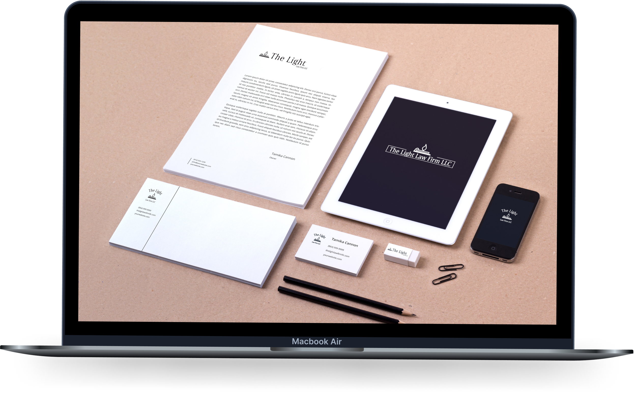 Laptop screen displaying a graphic design project with stationery items, a tablet, and a smartphone on a beige surface.