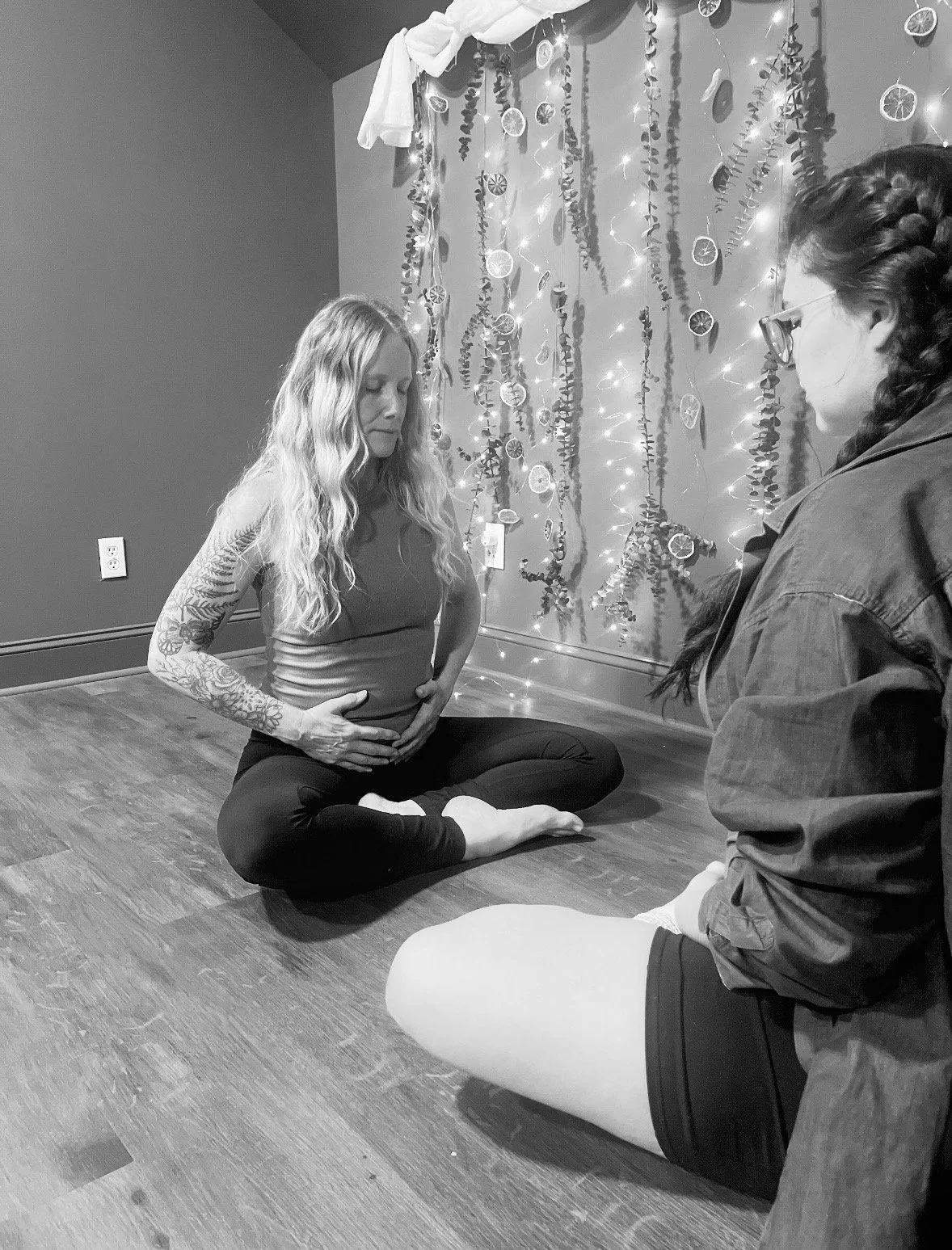 Two people holding hands, with one person's hand being gently supported during what appears to be a caring or comforting moment.