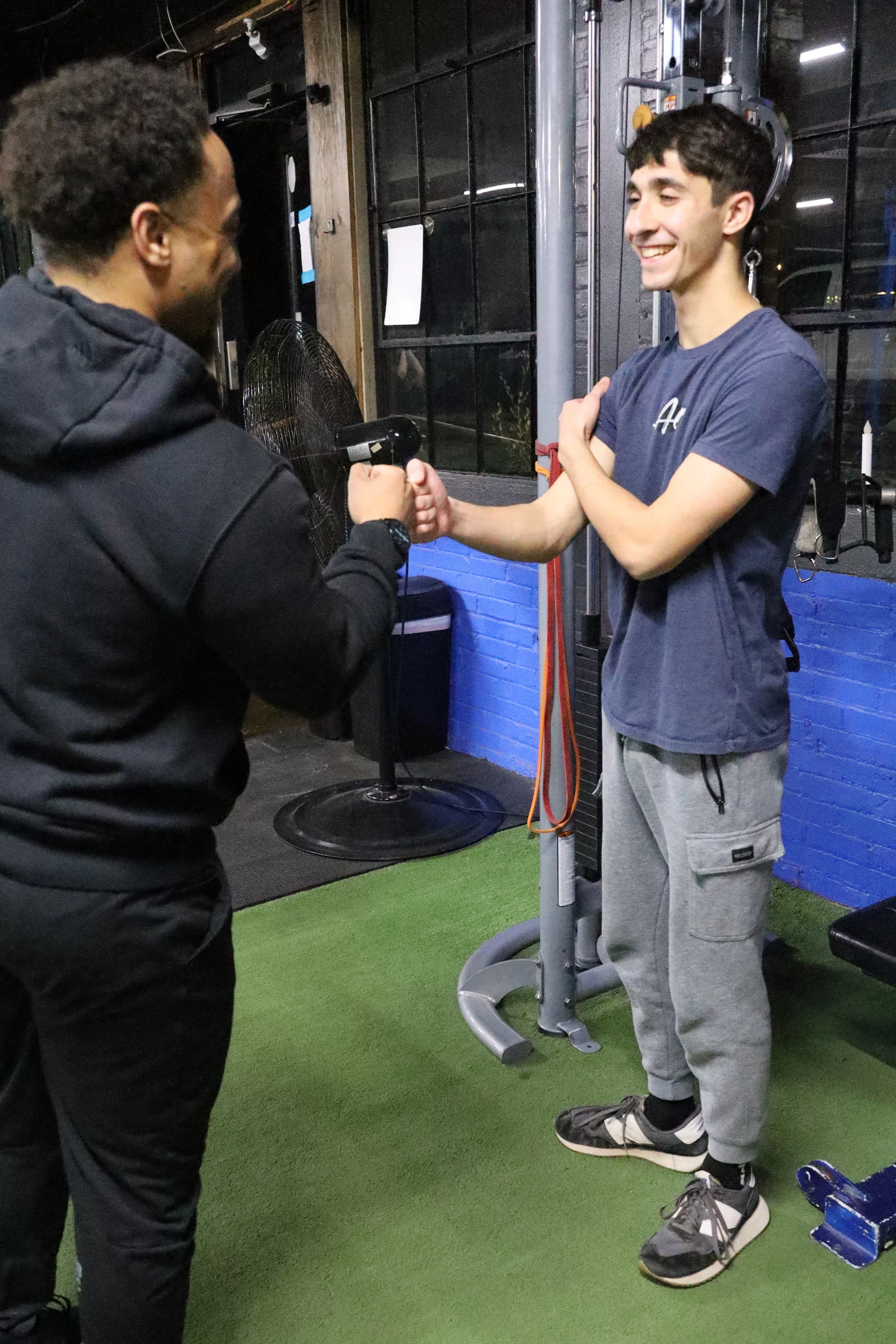 two people fist bumping