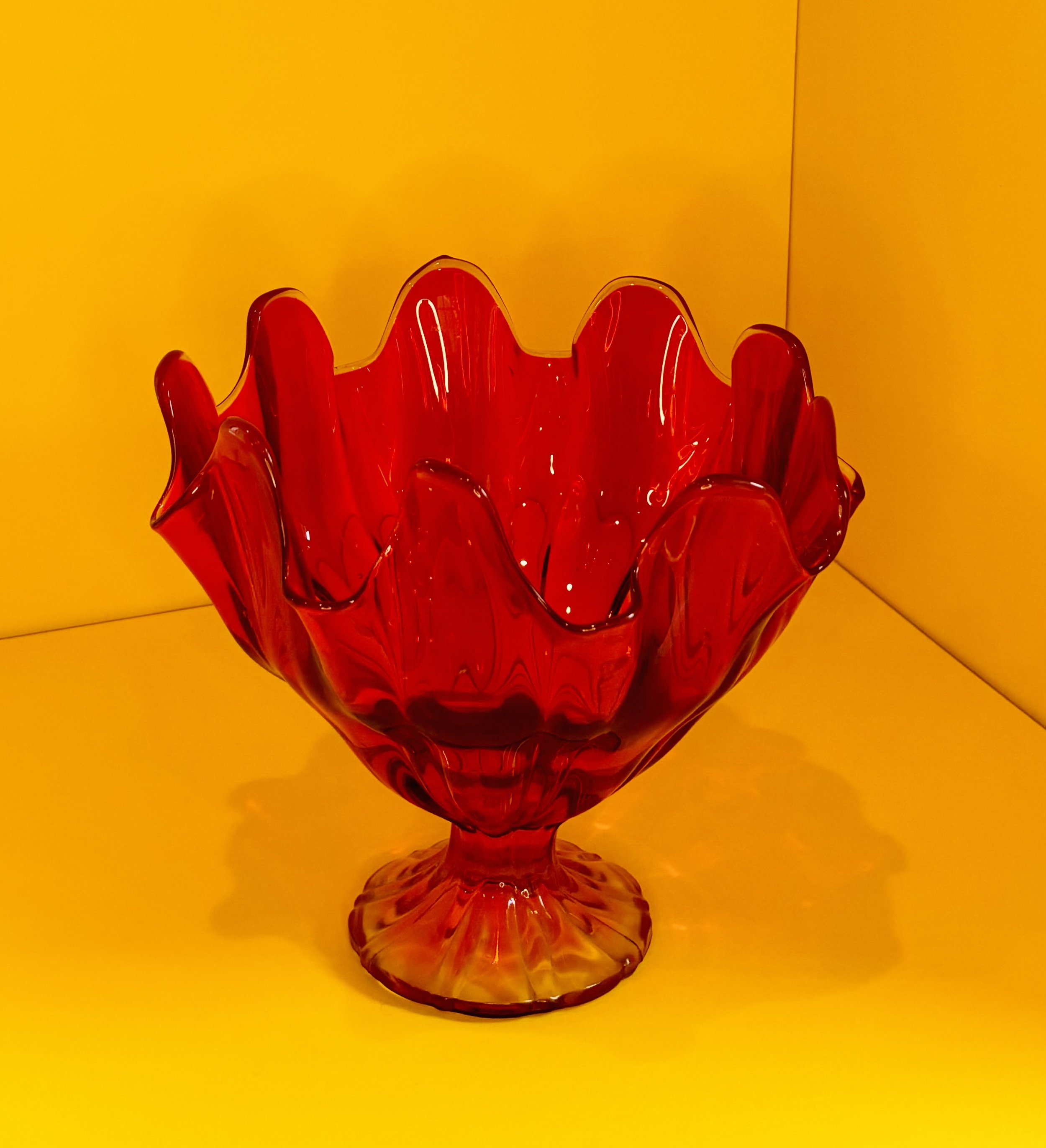 This L.E. SMITH HANDKERCHIEF BOWL is a prime example of AMBERINA glass: amber glass with some gold in the batch. The patented process gives glass a distinctive two-toned effect: ruby on top, yellow on the footed pedestal. Rare, beautiful and heavy, t