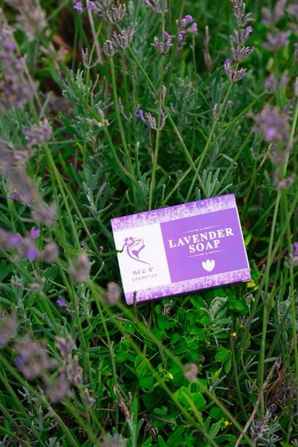 Lavendar soap in a field of lavendar on a beautiful sunny day, packaging is purple and white. 