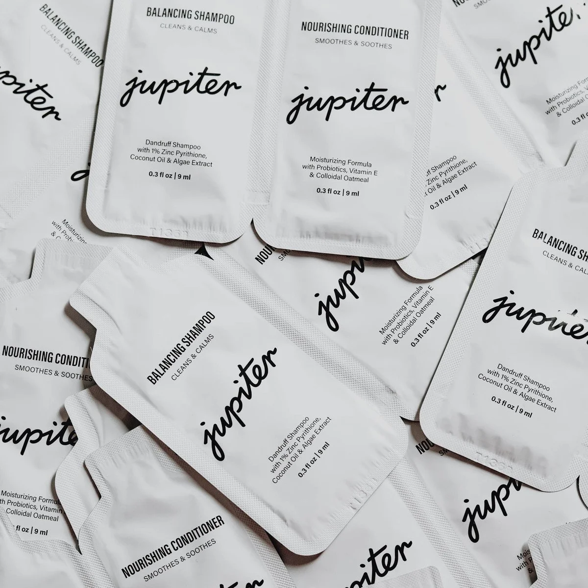 Packets of Jupiter Balancing Shampoo and Nourishing Conditioner.