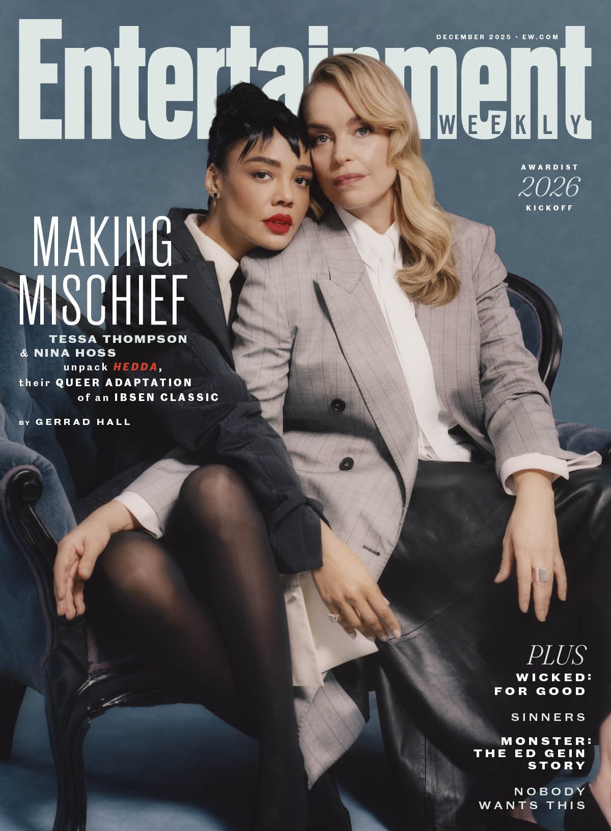 Cover of Entertainment Weekly magazine featuring two women sitting close together on a blue sofa. One woman has short black hair and wears a black jacket, black tights, and accents of white, while the other has blonde hair and wears a checkered blaze
