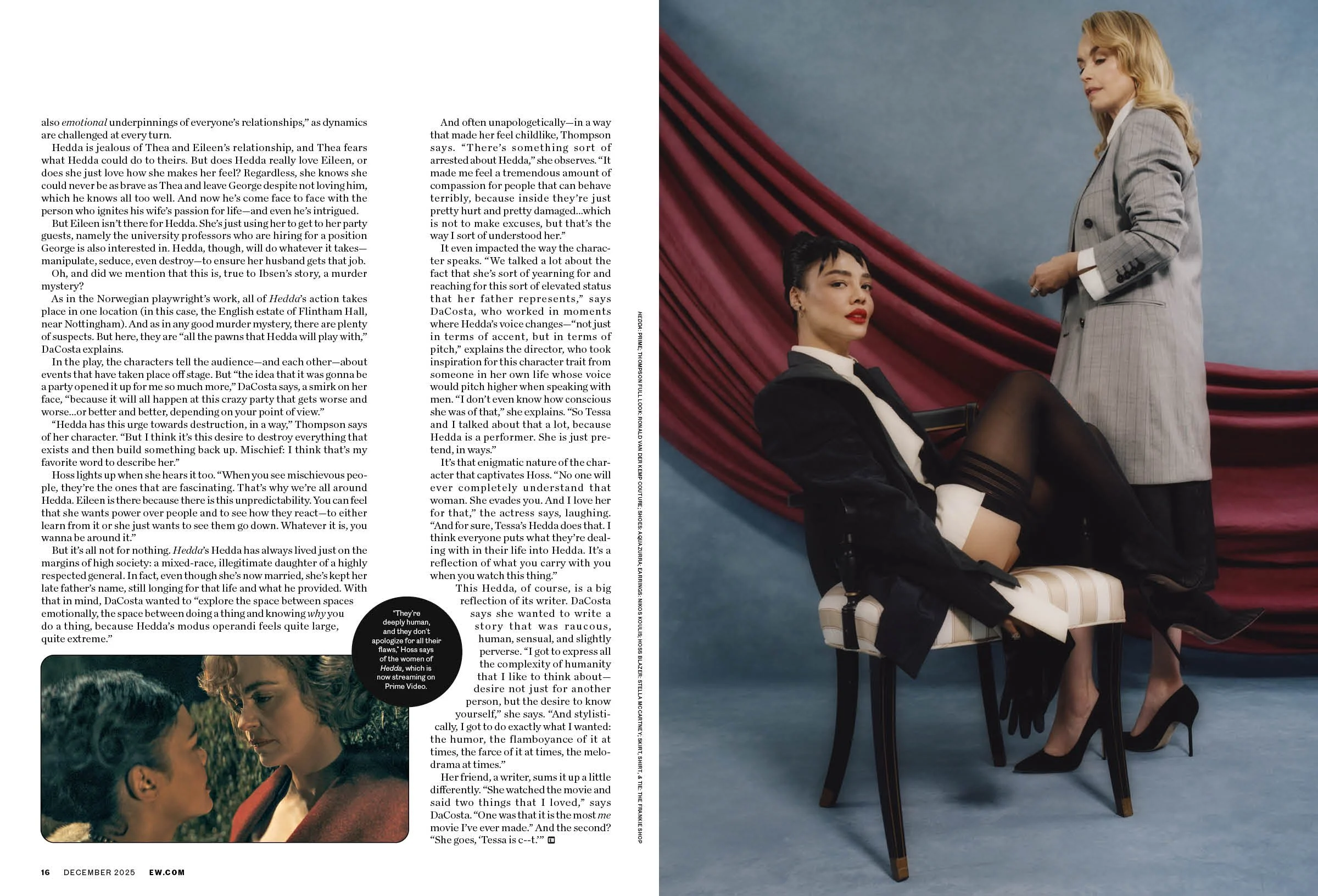 Two women in a photoshoot setting; one woman with blonde hair in a gray plaid suit sits on a chair, legs crossed, looking down; the other woman with dark hair in a black blazer, white shirt, and black shorts sits on a chair with one leg over the othe