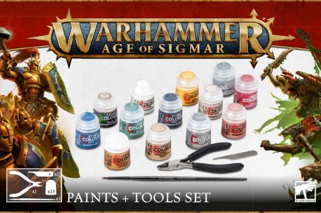 Warhammer Age of Sigmar Paints and Tools Set with various paint bottles and brushes displayed, featuring game characters in armor and weapons on the box.