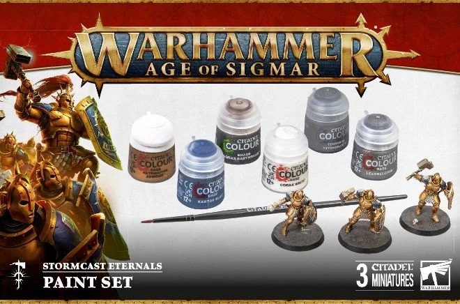 Warhammer Age of Sigmar Stormcast Eternals paint set with five miniature figures and five paint pots on a white surface, with game branding and artwork on the packaging.