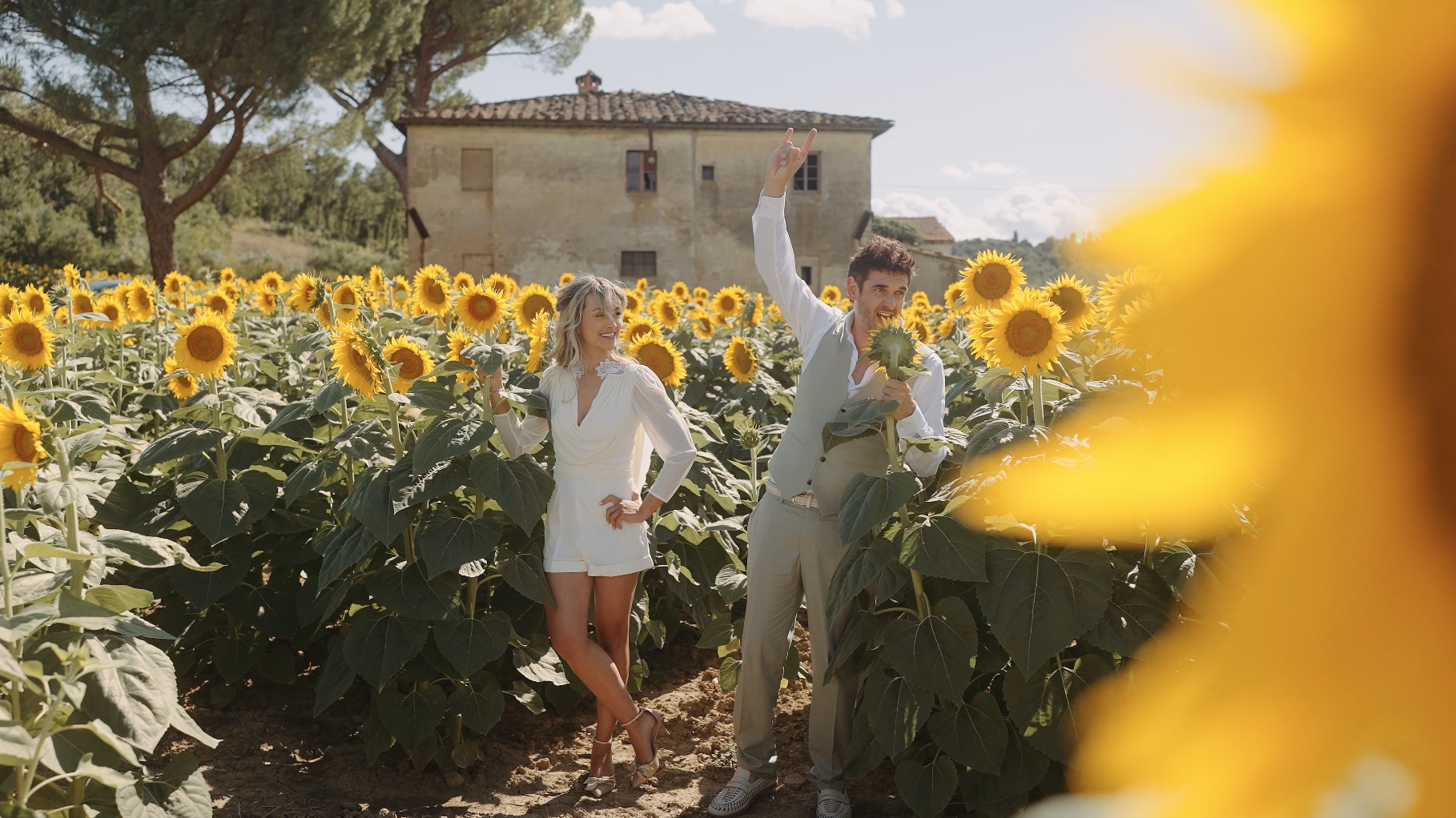 Bride and groom celebrating in a Tuscan sunflower field; a still from the 2025 Way Up North Film of the Year by Maru Films.