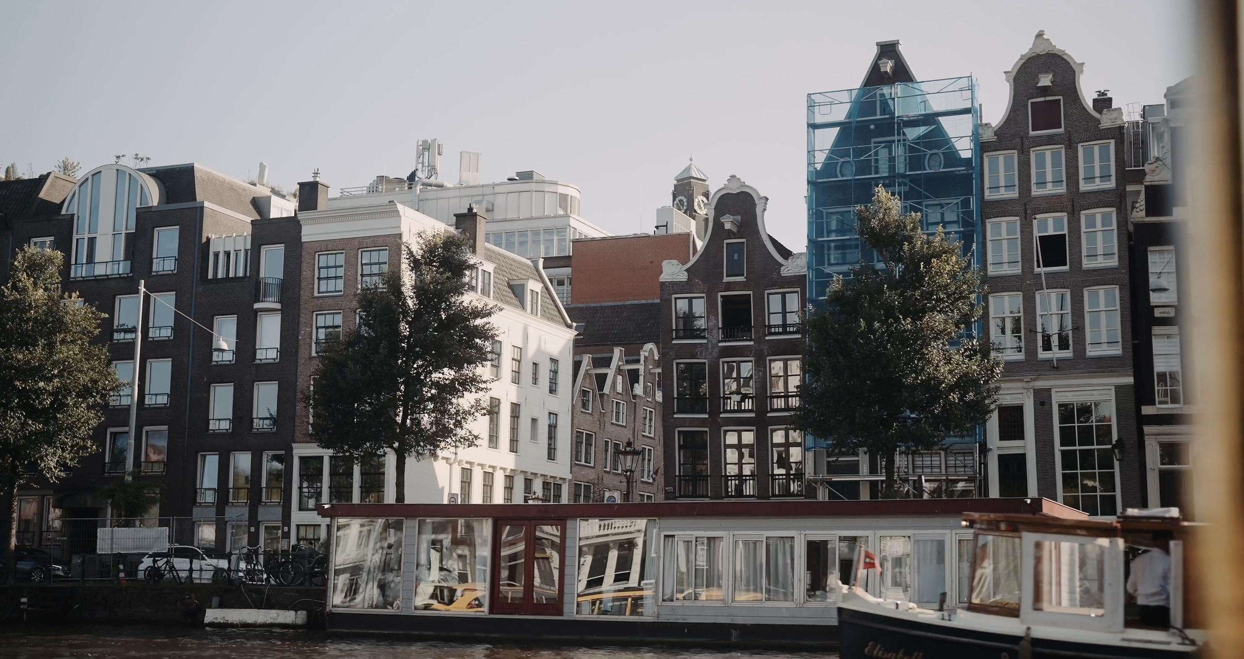 Cinematic view of historic canal houses in Amsterdam, Netherlands. Editorial wedding photography location inspiration by Maru Films.