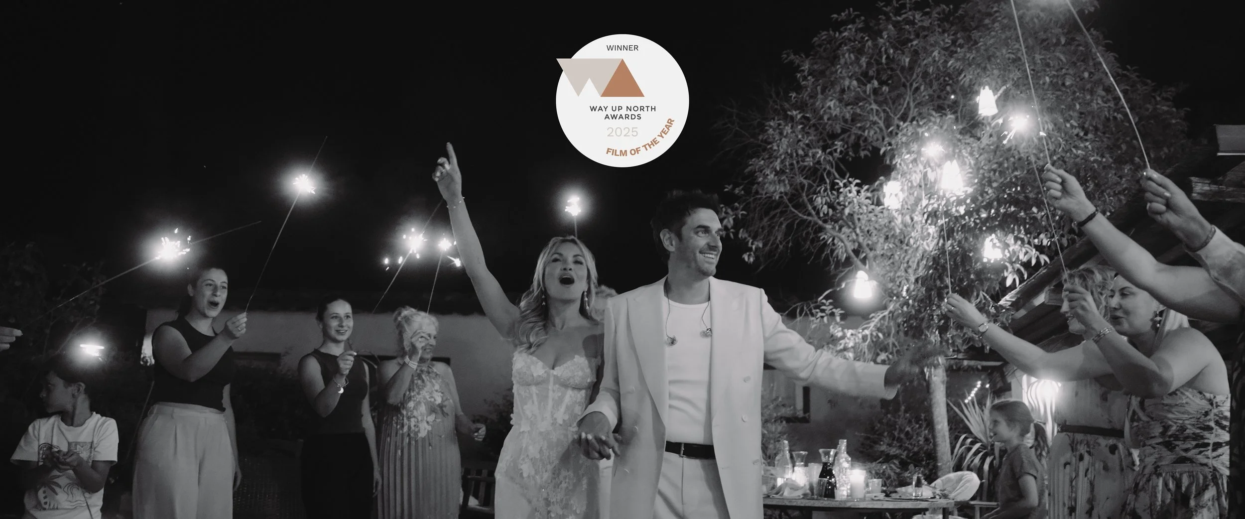 Maru Films wedding videography still from the Way Up North 2025 Film of the Year winner, featuring a bride and groom celebrating with sparklers at their Tuscany wedding.