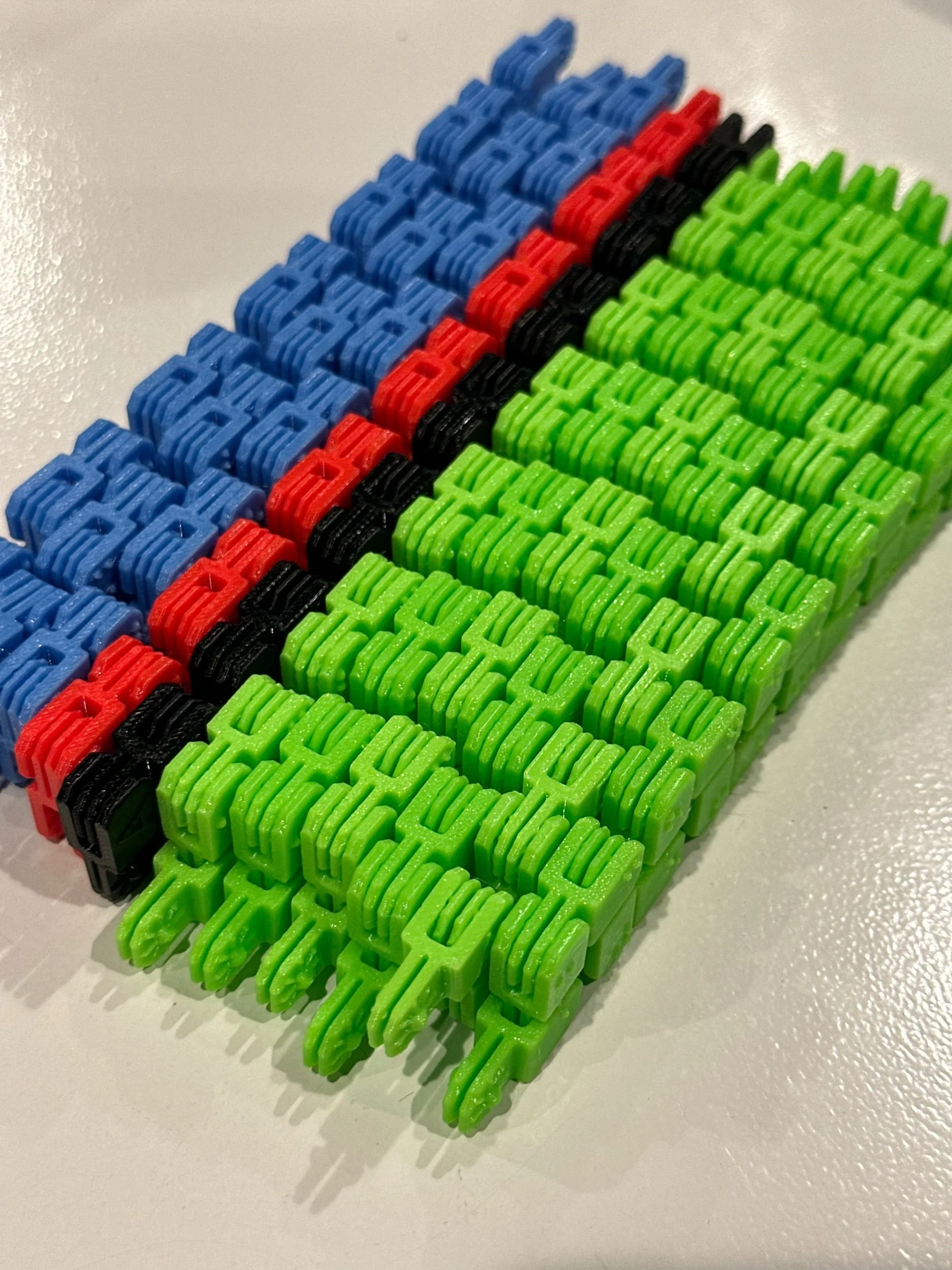 Bundle of fidgets lined up side by side, each in an accordion fold.