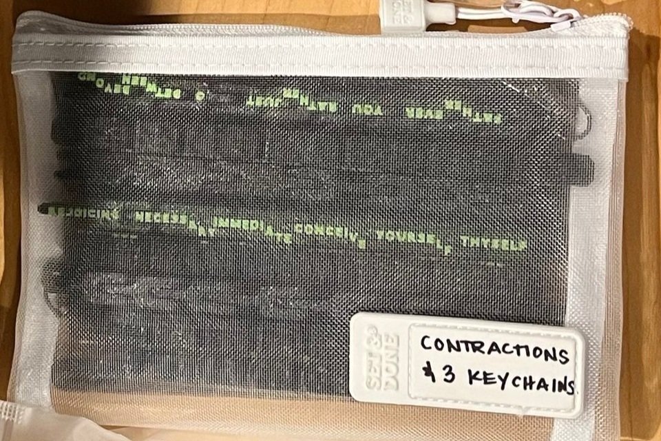 Black contractions fidgets in a fabric mesh zippered bag.
