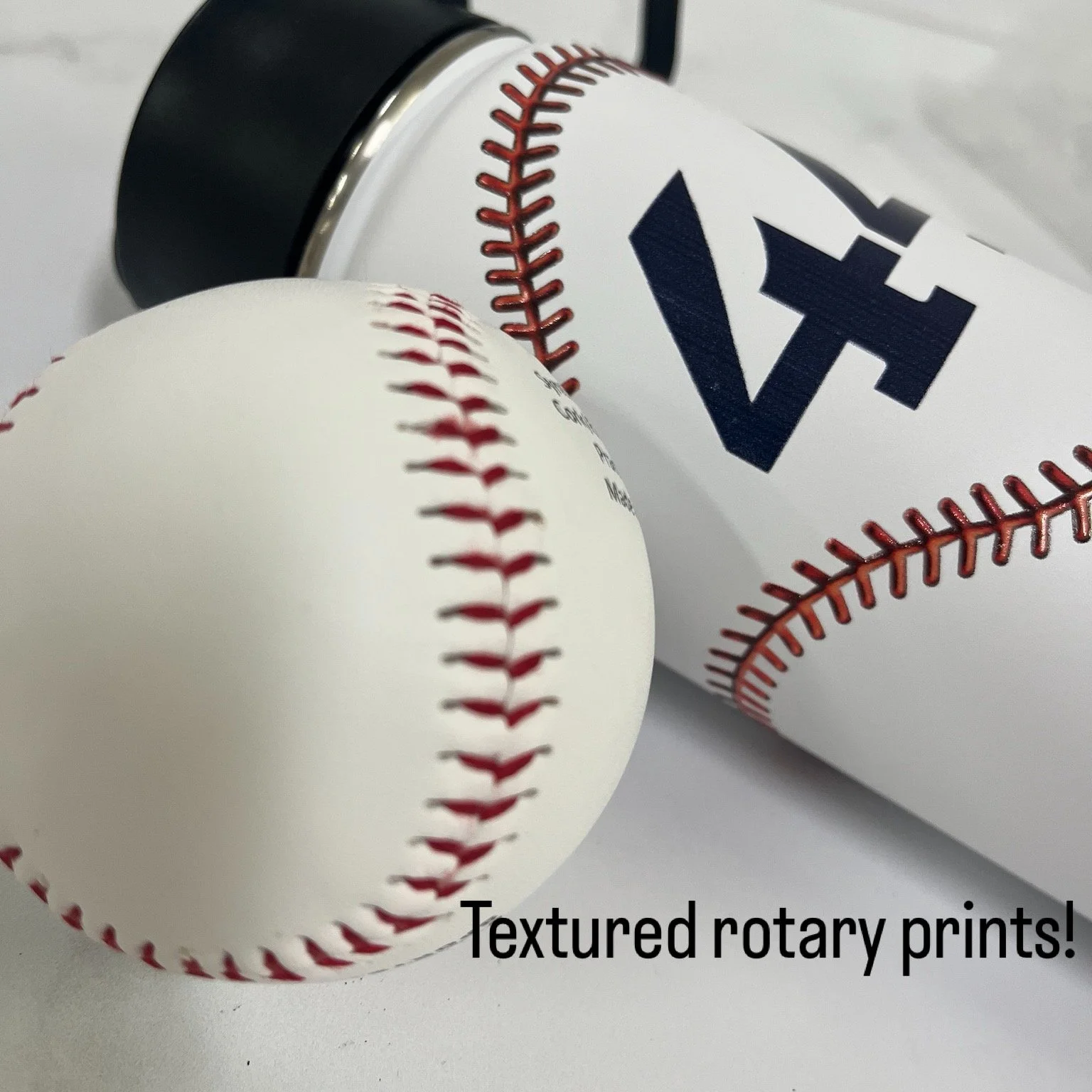 A baseball with textured red rotary stitching in the foreground, and a paper cup with a baseball logo and textured red rotary stitching in the background, on a white surface. Caption reads 'Textured rotary prints!'.
